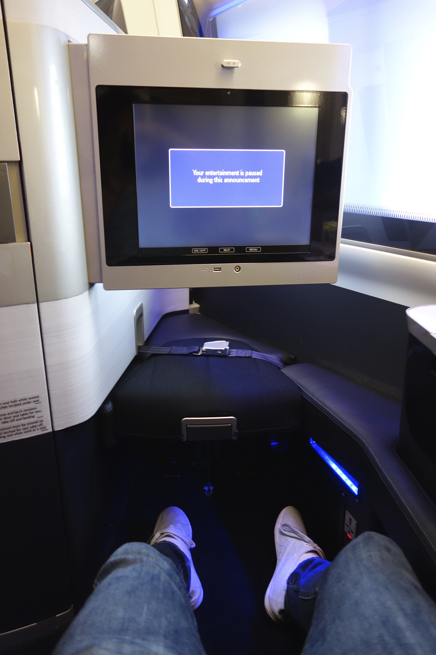 Footrest with seatbelt and in-flight entertainment
