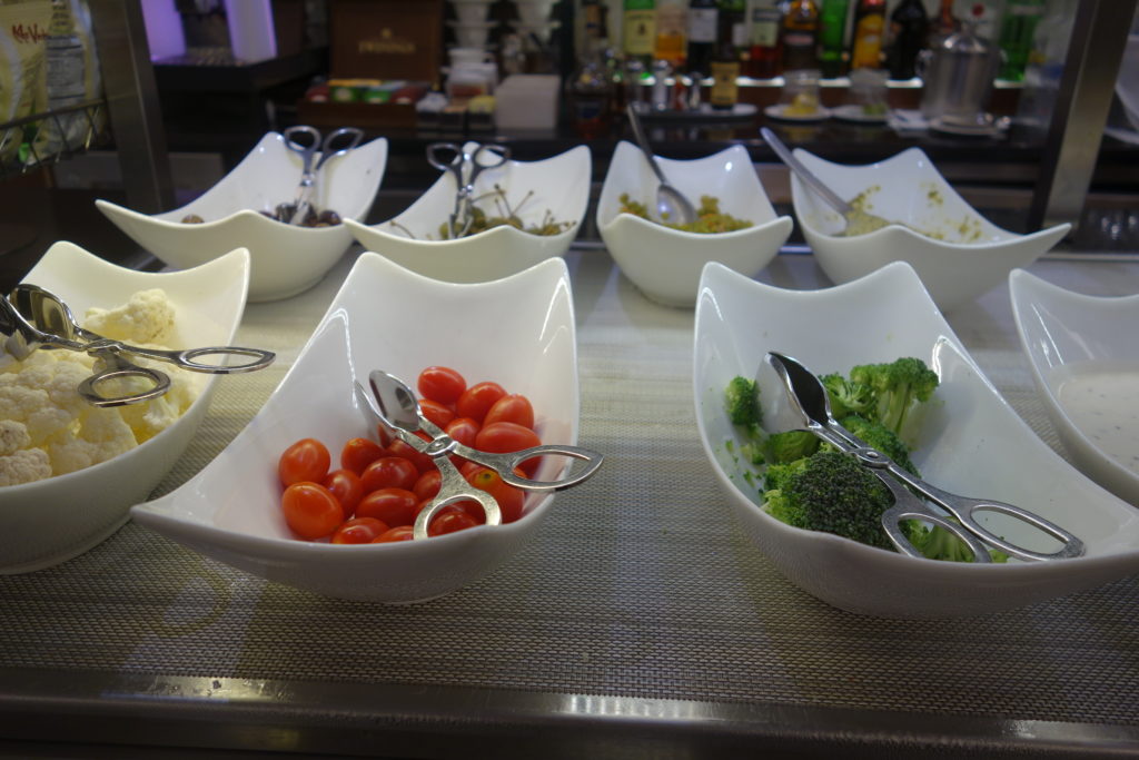 a group of white bowls with vegetables in them