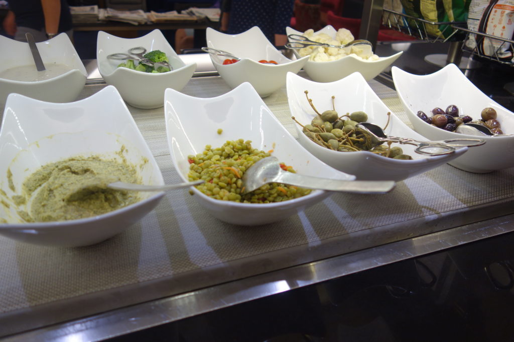 a group of white bowls with different foods in them