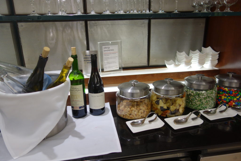 a buffet table with food and wine bottles
