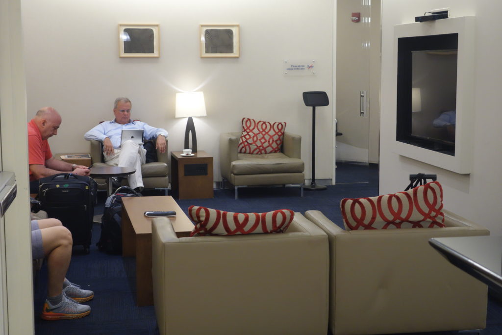 a man sitting in a chair in a room with a television