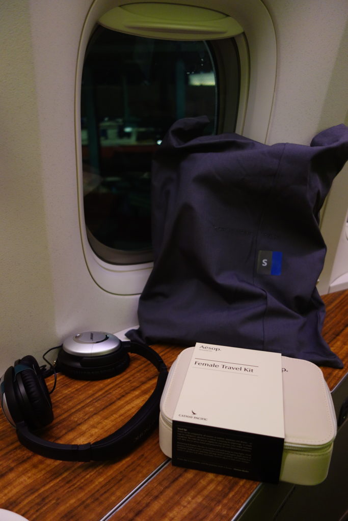 a headphones and a book on a table next to a window