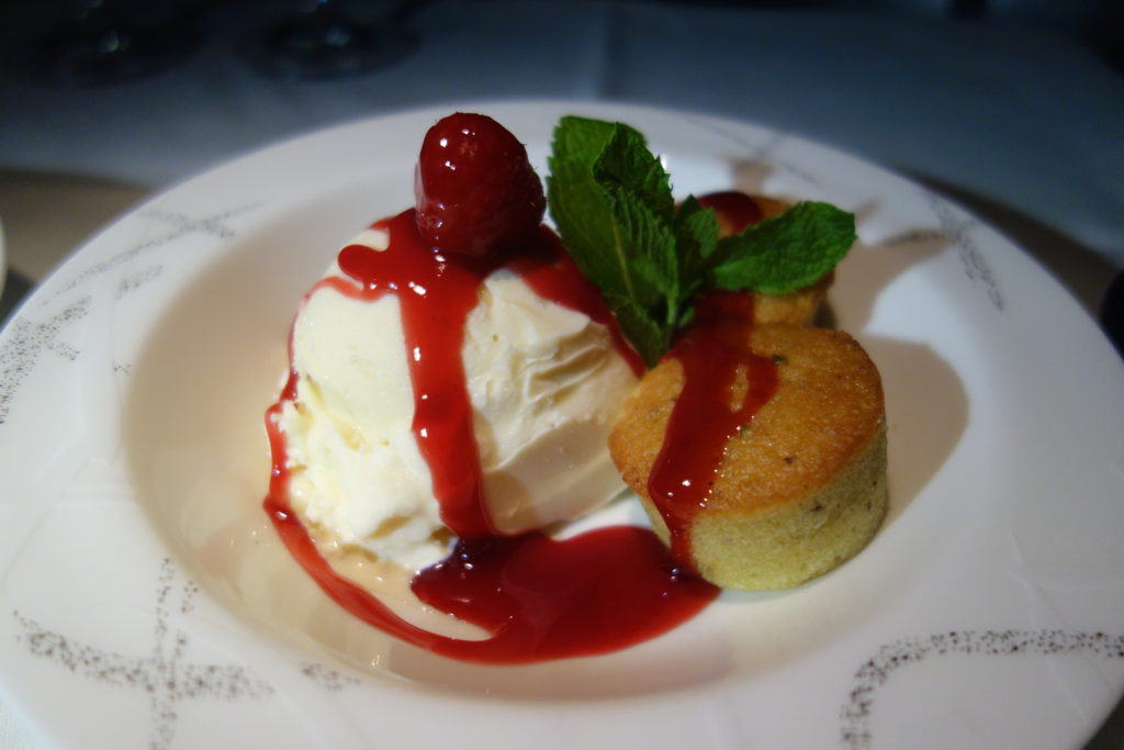 a plate of food with a strawberry sauce on top