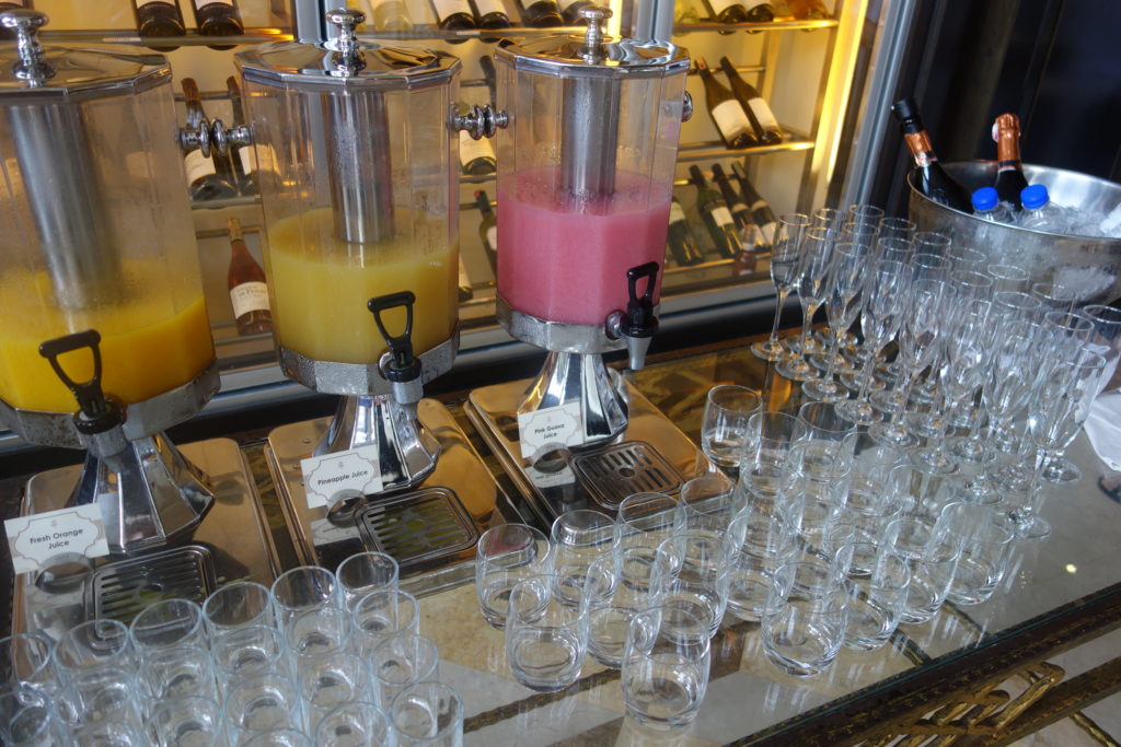 a group of glasses and juice dispensers on a table