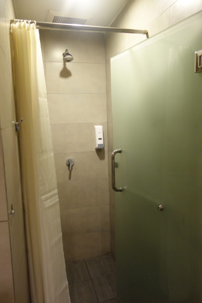 a shower with a green door