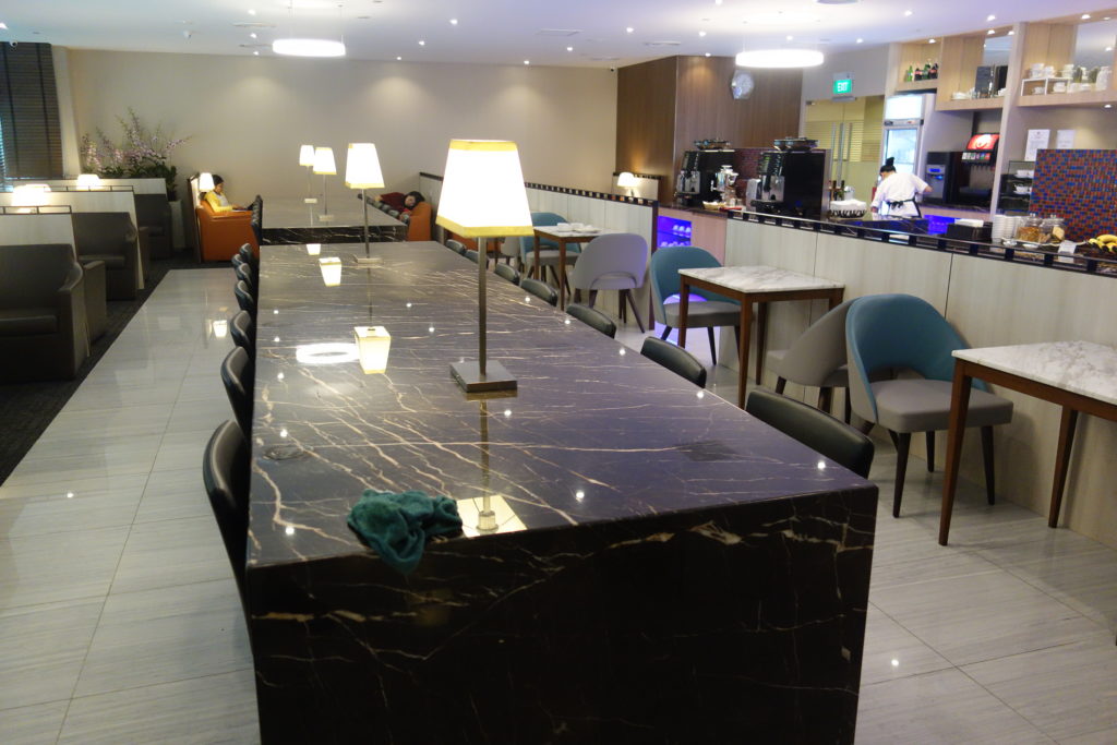 a long rectangular table with lamps on it