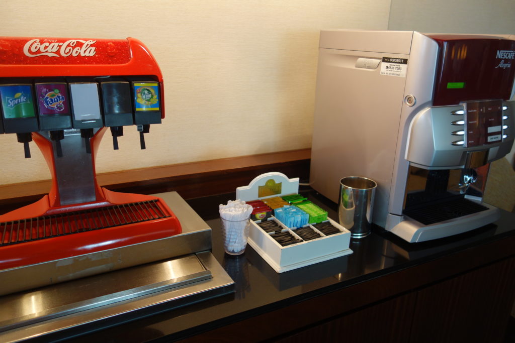 a coffee machine and a container of sugar
