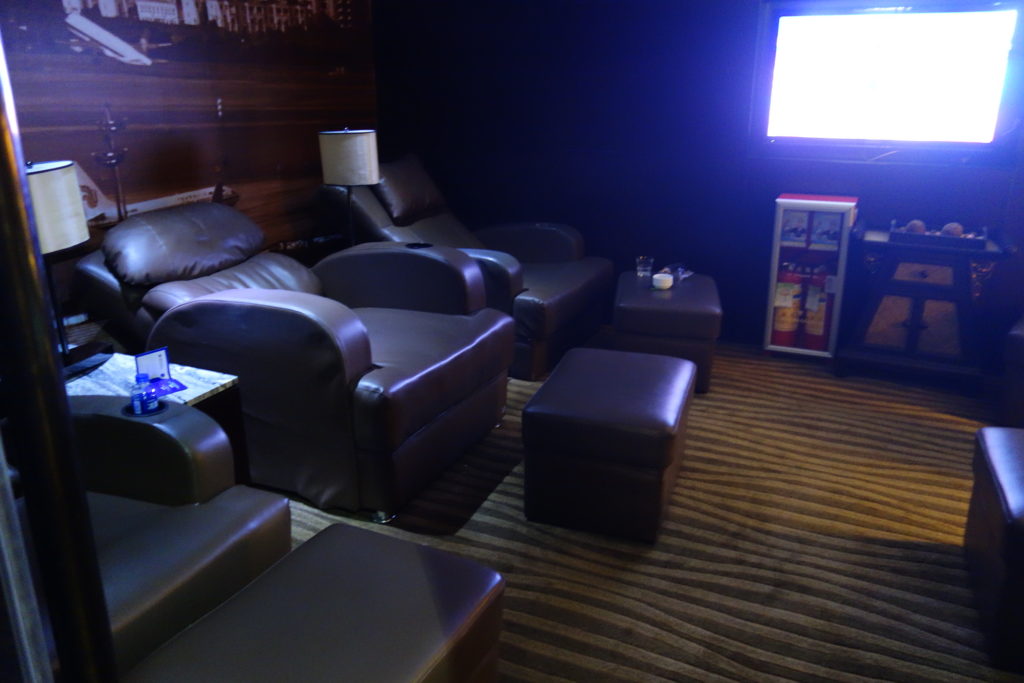 a room with leather chairs and a tv