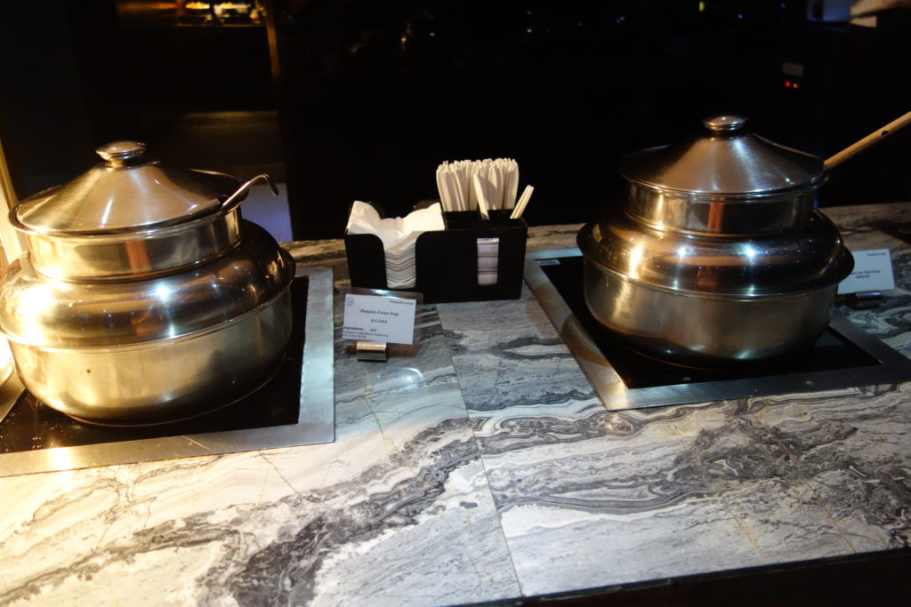 a two metal pots on a counter