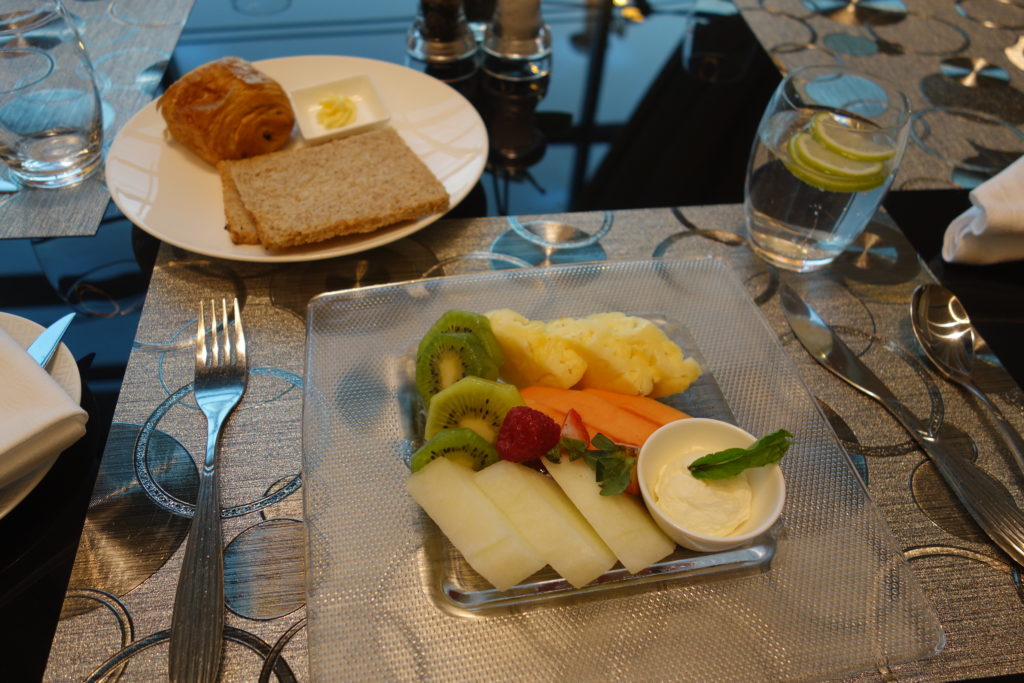 a plate of fruit and bread on a table