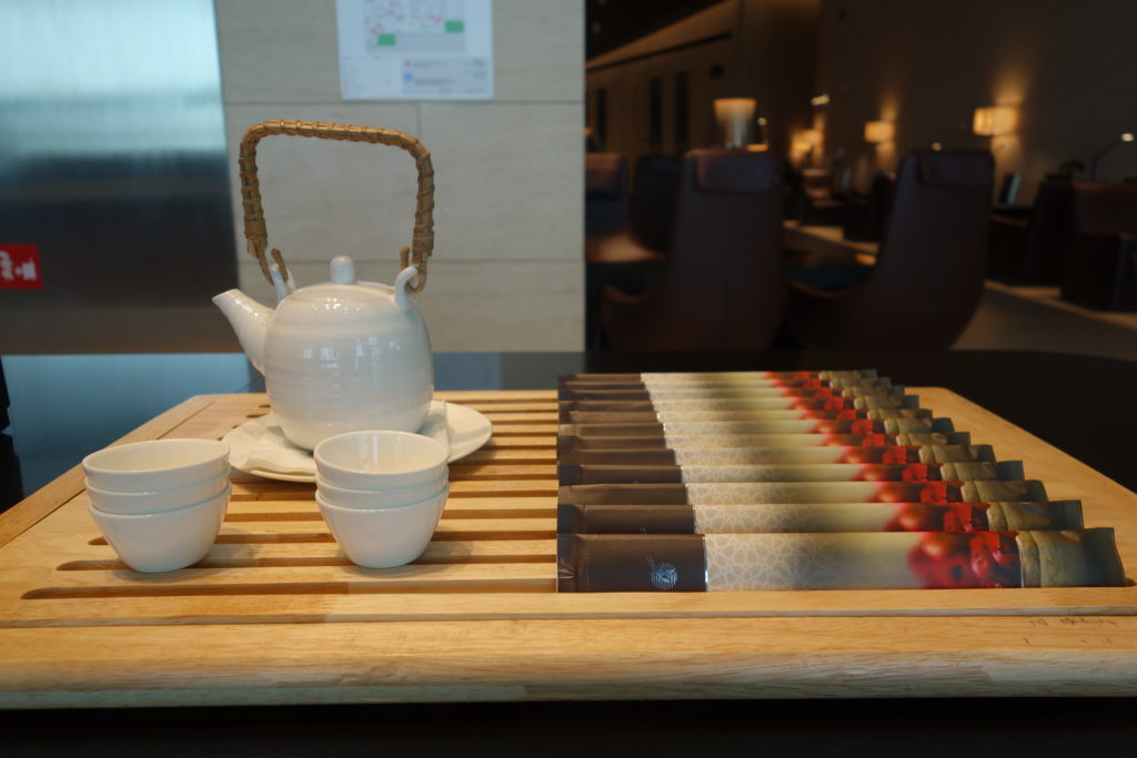 a teapot and cups on a wooden tray