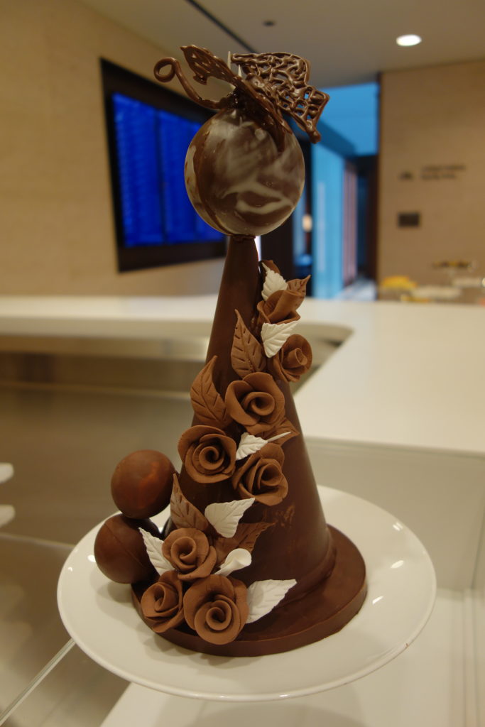 a chocolate cone with flowers and a ball on top