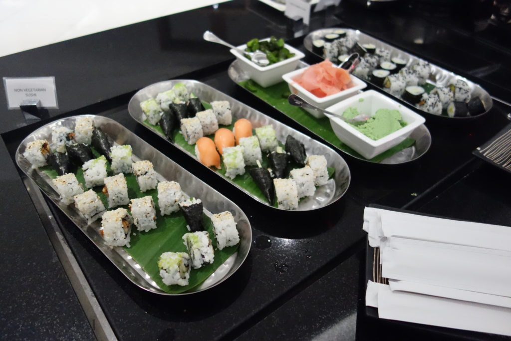 a trays of sushi on a black surface