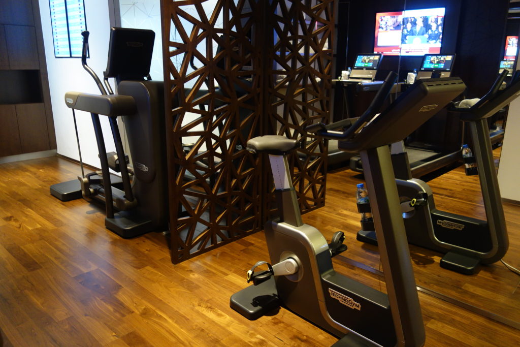 a room with exercise bikes and a screen