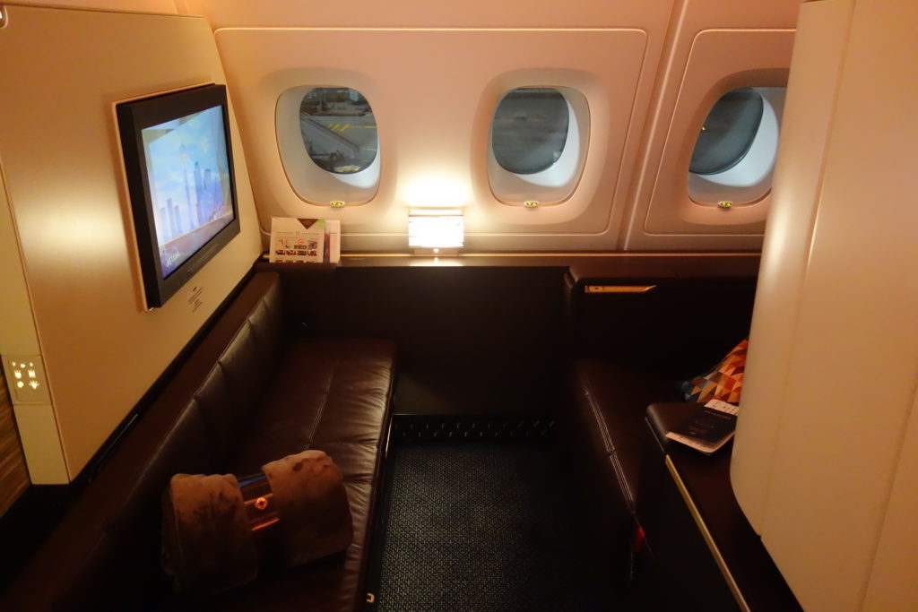 a seat in an airplane with windows and a television