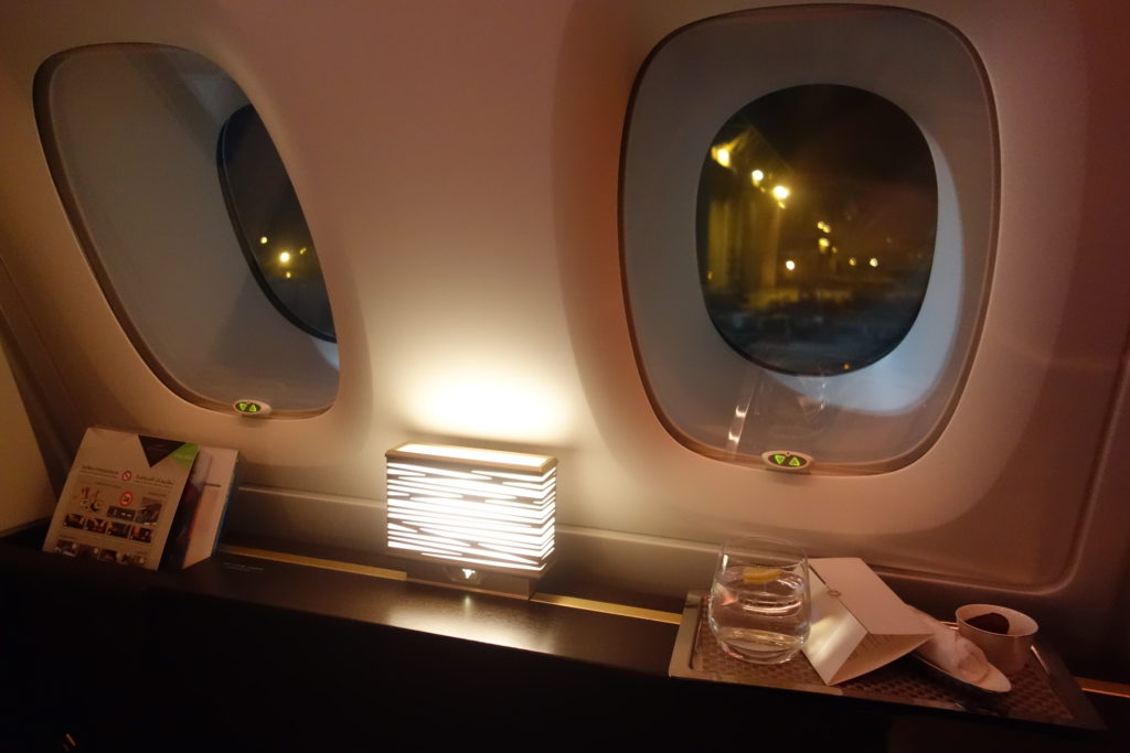 a window with lights and a lamp on the side of the plane