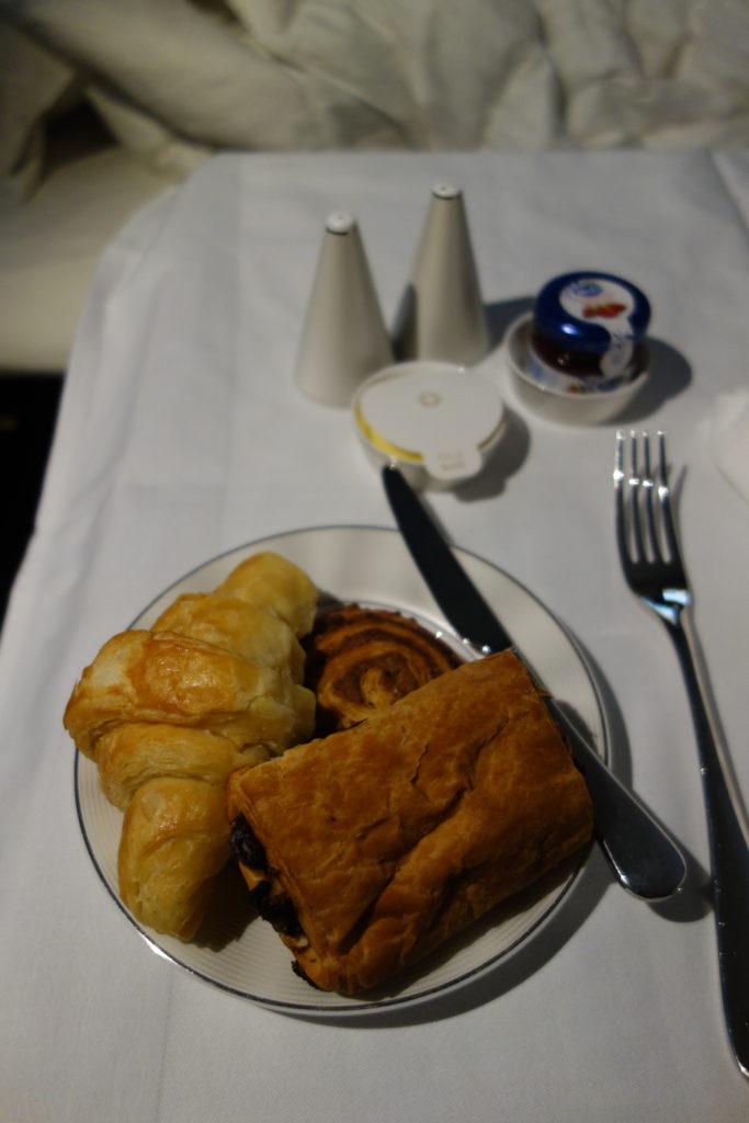a plate of pastries and a fork on a table