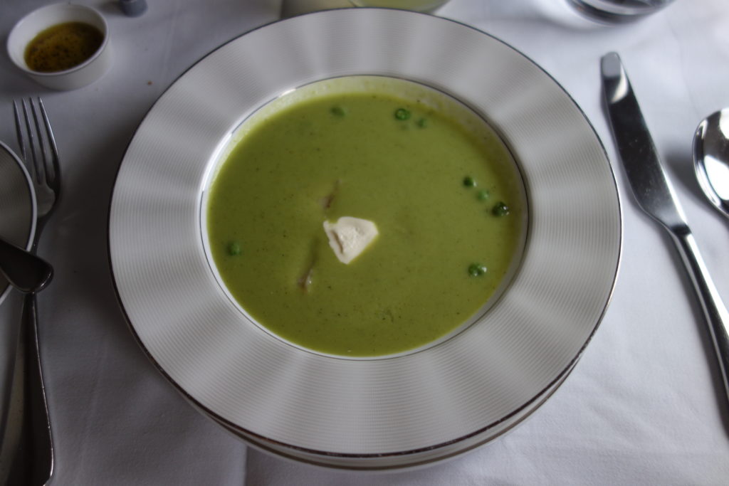 a bowl of green soup with butter