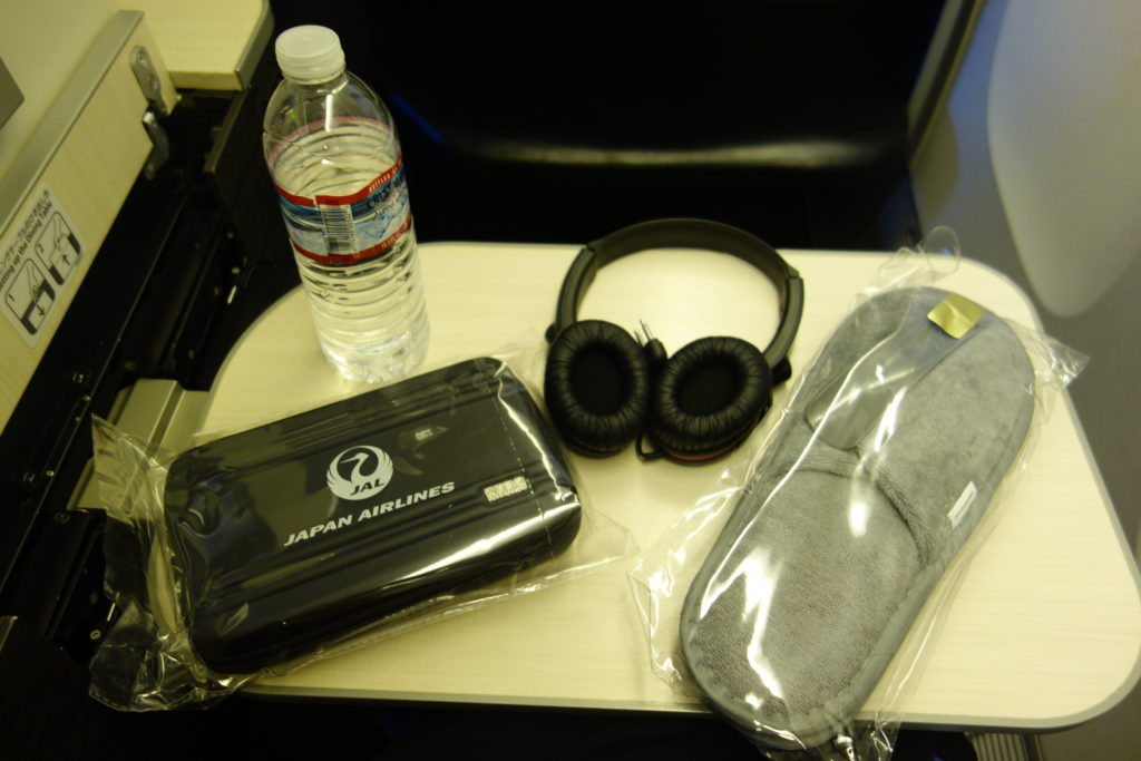 a table with a pair of headphones and a bag of water