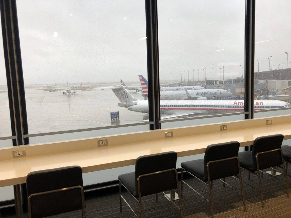 a row of chairs and tables in an airport