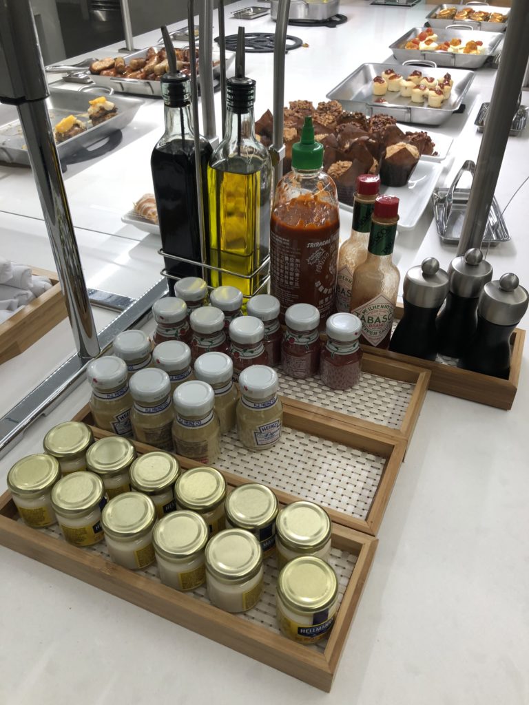a group of condiments and bottles on a counter