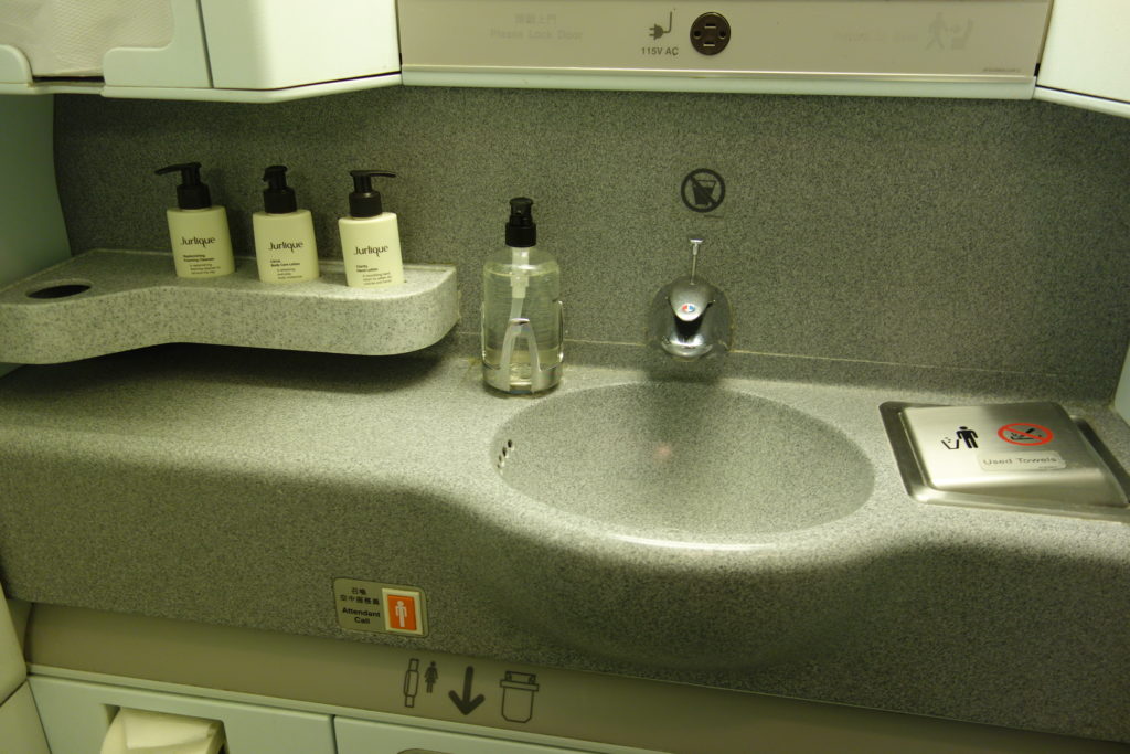 a sink with soap dispensers and bottles of liquid