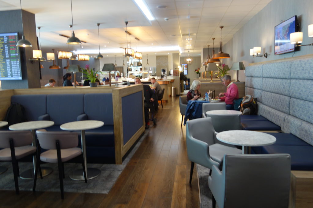 a group of people sitting at tables in a restaurant