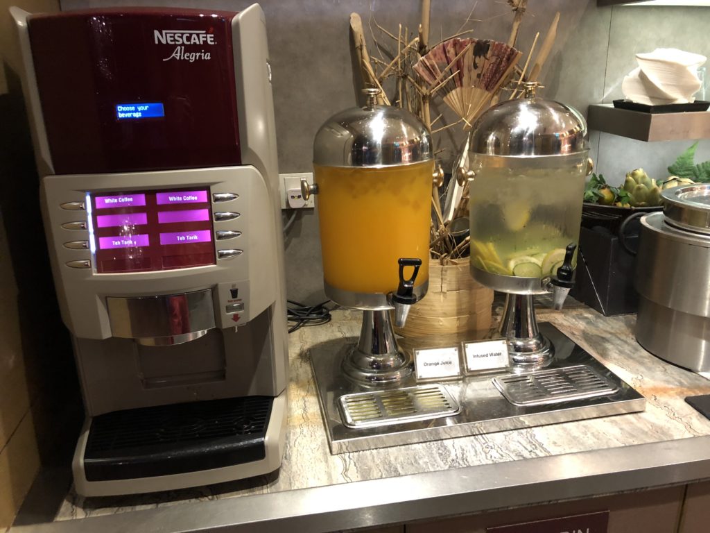 a machine with a drink dispenser next to it