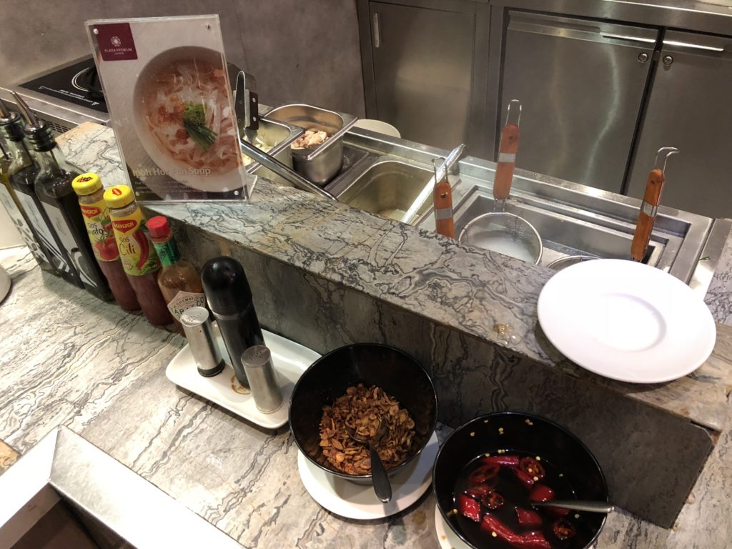 a kitchen with a counter and a sink and food