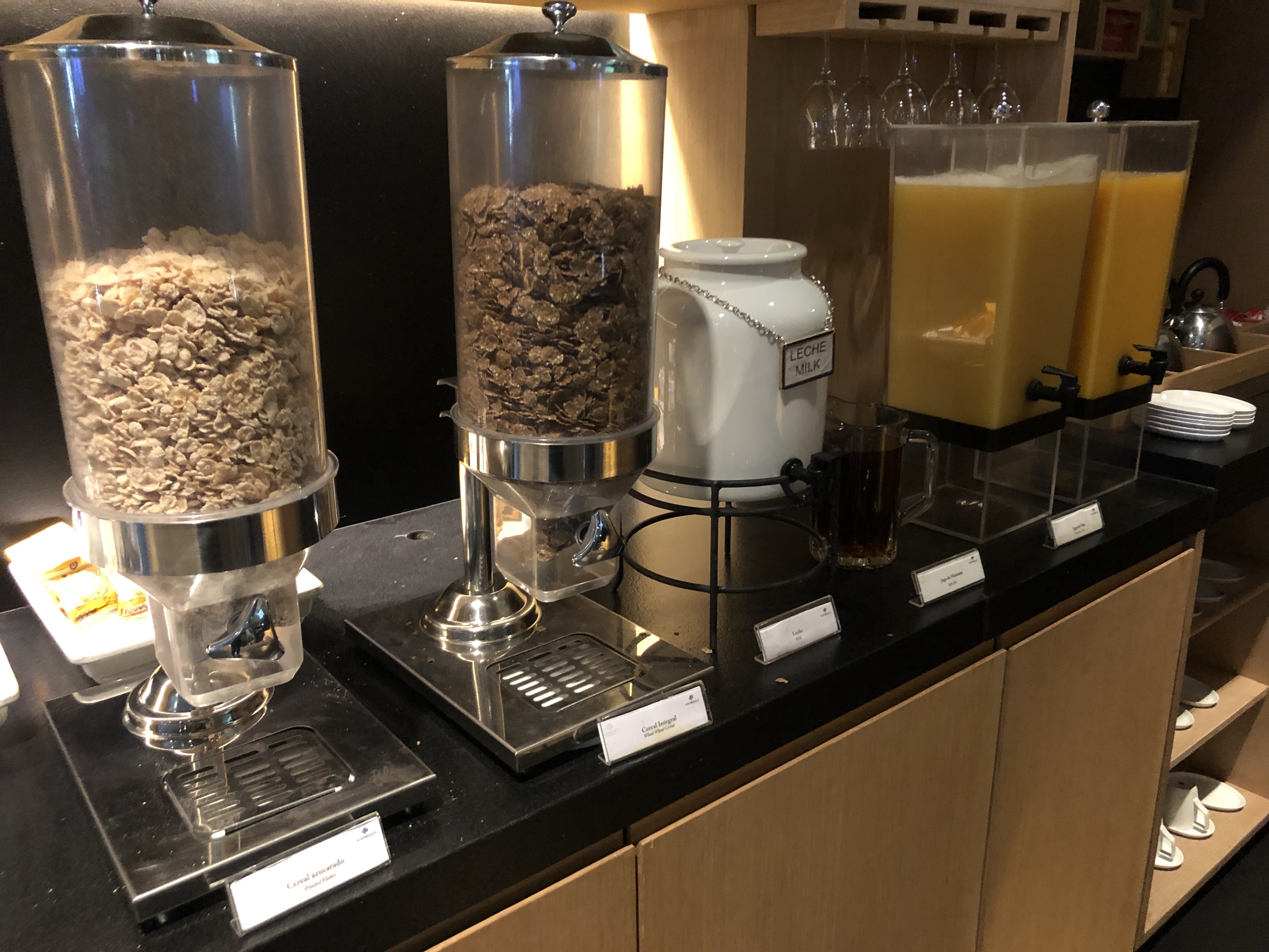a breakfast buffet with cereal and juice
