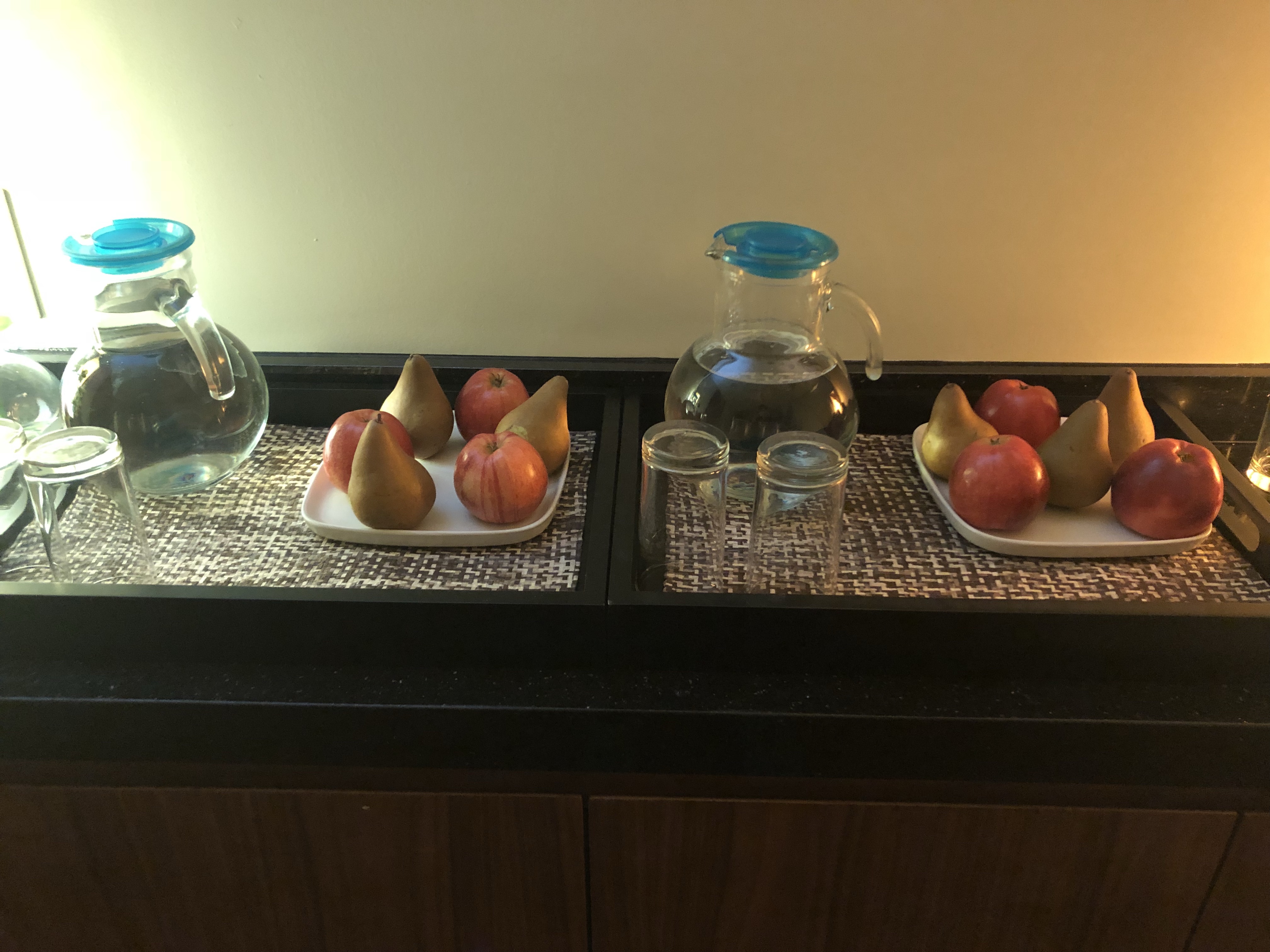 a tray of fruit and water on a table