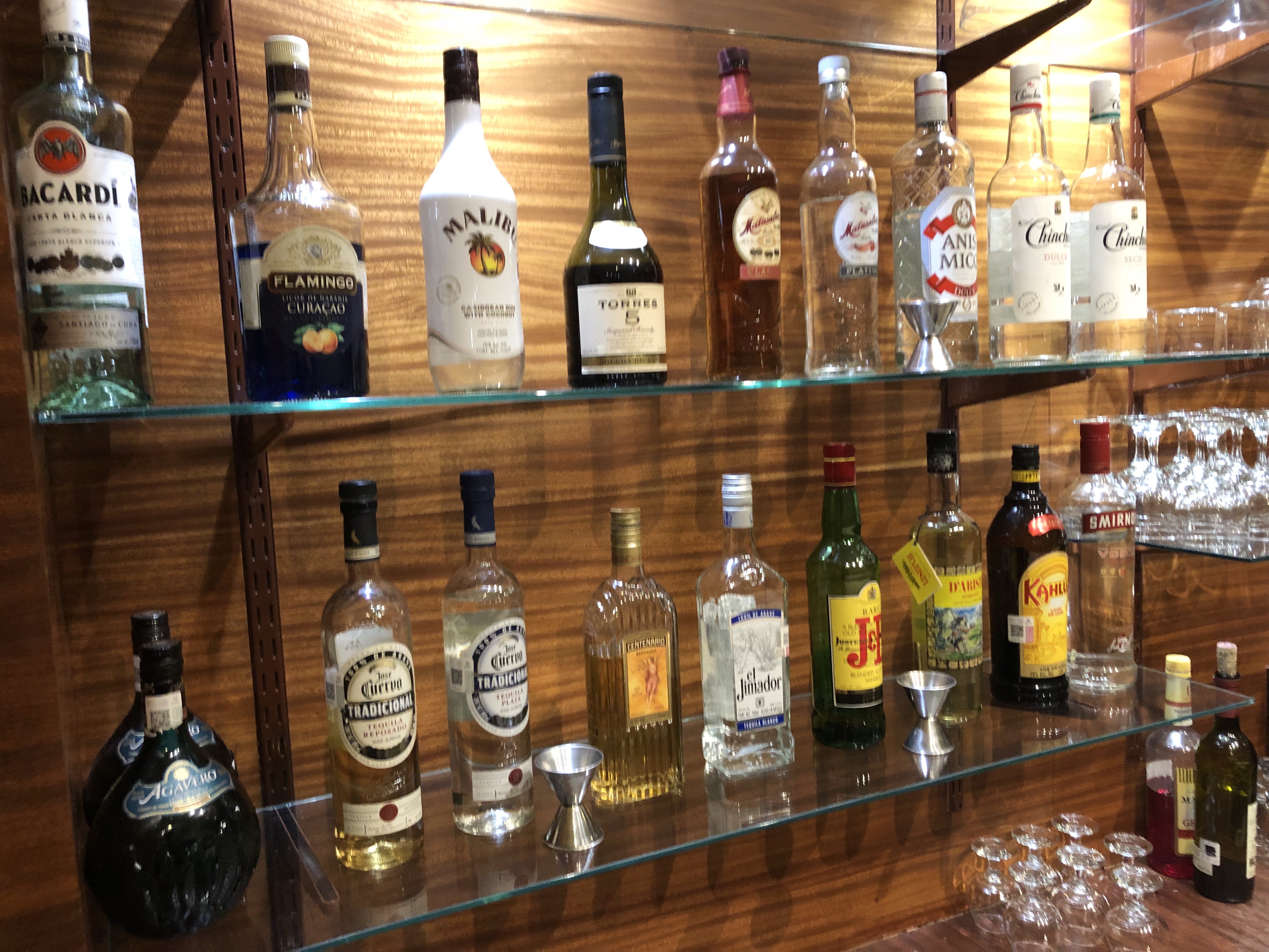 a shelf with bottles of alcohol