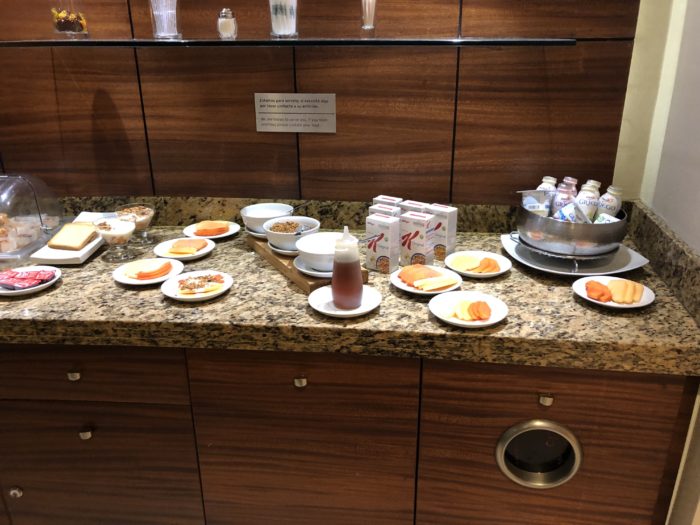 a counter with plates of food and drinks on it