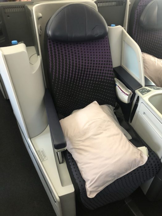 a seat with a pillow and a pillow on the back